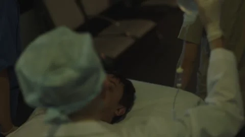 Doctors taking the ill patient to the other part of the hospital Stock Footage 283147597