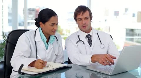 Doctors taking information on internet Stockbeeldmateriaal 10860525