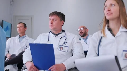 Doctors taking notes and asking questions during seminar Stock Footage 316911651