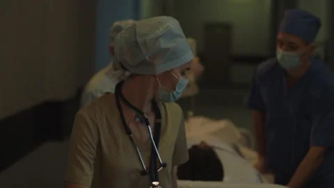 Doctors taking the patient somewhere Stock Footage 283147729