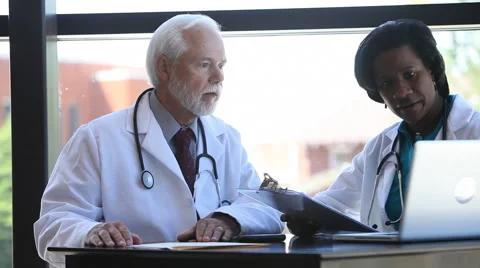 Doctors talking over charts Stock Footage 62281108