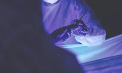 Doctors team in surgery in a dark background. Stock Photos