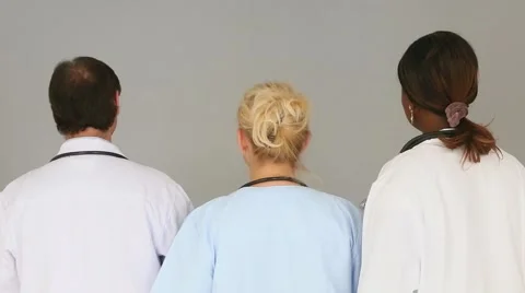 Doctors turning around to look at the camera in the same moment Stock Footage 52244435