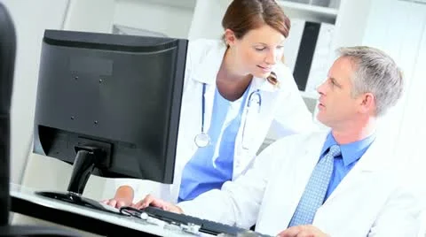 Doctors Using Clinical Computer Data Video stock 11365977