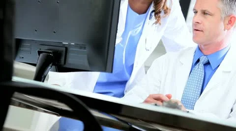 Doctors Using Clinical Computer Data Video stock 11367528