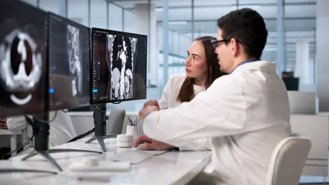 Doctors Using Computer X-ray Bone Imaging Before Stock Footage 328404860
