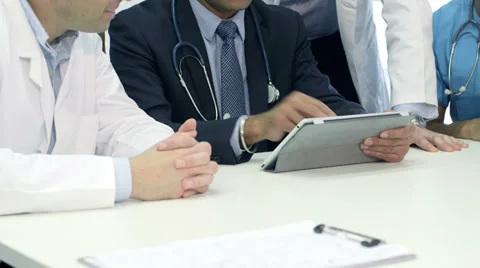Doctors using a digital tablet in a meeting. Stock Footage 36099778