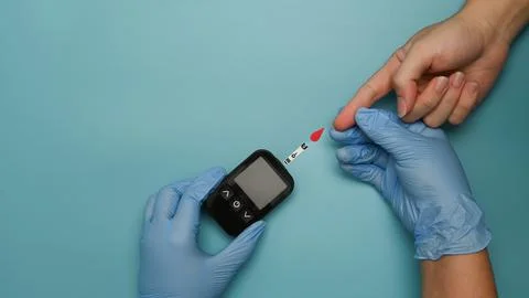 Doctors using glucometer for checking blood sugar level. Diabetes control and 스톡 사진