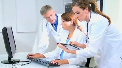 Doctors Using Patient Clinical Computer Tablet Data Stock Footage