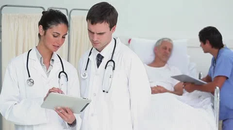 Doctors using a tablet computer Video stock 10858268