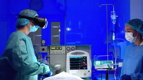 Doctors in VR glasses performing surgery in hospital Stock Footage 140751806