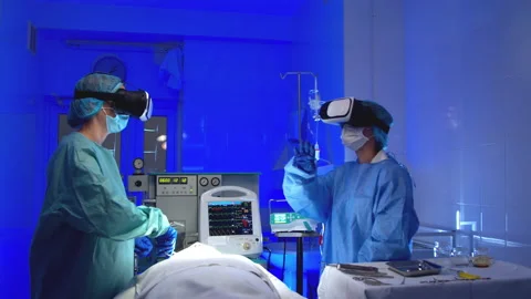 Doctors in VR glasses performing surgery in hospital Stock Footage 140765644