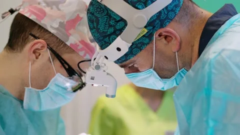 Doctors work in operating theater. Faces of medical specialists in masks Stock Footage 133402291