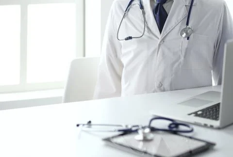 Doctors working on computer at hospital. Stock Photos