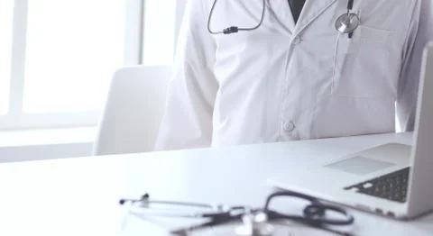 Doctors working on computer at hospital. Stock Photos