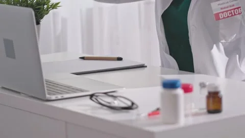 Doctor's working day. unrecognizable doctor in white coat put on stethoscope Stock Footage 230107457