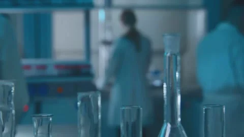 Doctors Working in Modern Chemical Laboratory With Flasks and Equipment Видео 334563243