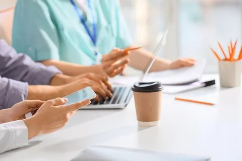 Doctors working at table in clinic, closeup Stock Photos
