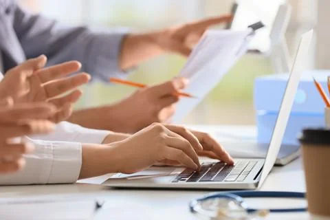 Doctors working at table in clinic, closeup Stock Photos
