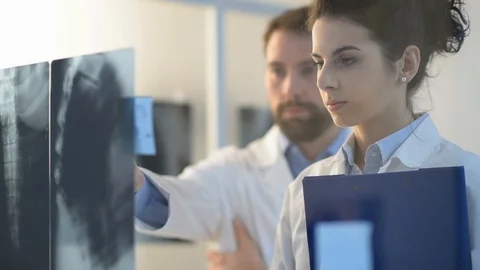 Doctors working together and examining an x-ray Stock Footage 86682200