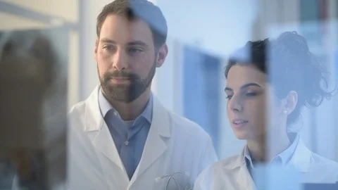 Doctors working together and examining an x-ray Stock Footage 86682567