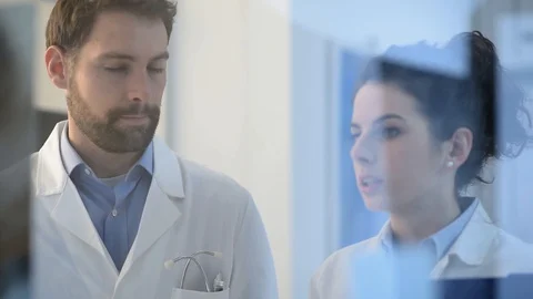 Doctors working together and examining an x-ray Stock Footage 86684098