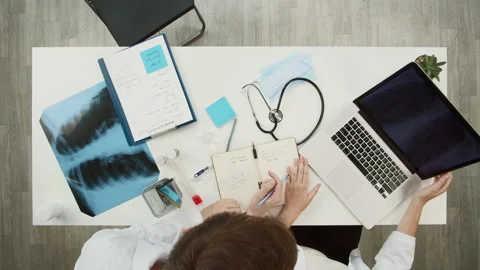 Doctors working together top view. Woman nurse showing lungs x-ray on laptop Stock Footage 160278997