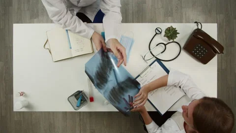 Doctors working together top view. Nurse showing ribs on x-ray, helping Stock Footage 162328164