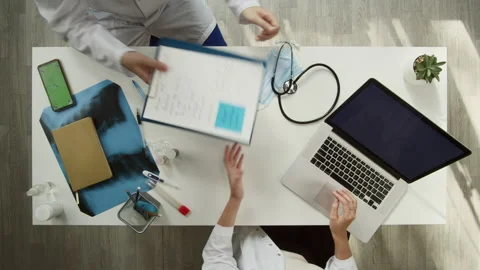 Doctors working together top view. Woman nurse typing on laptop computer. Man Stock Footage 163039420