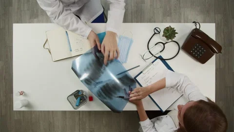 Doctors working together top view. Nurse writing diseases in medical card Stock Footage 163612335
