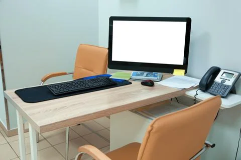 Doctor's workplace with computer in modern clinic. Space for design Stock Photos