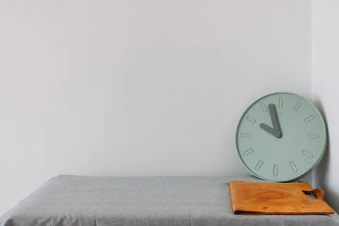 Document bag and clock on the table with empty space. Concept of work and time. Stock Photos