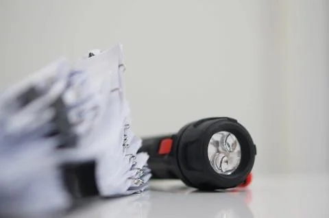 Document with clips on desk for report and flashlight Stock Photos