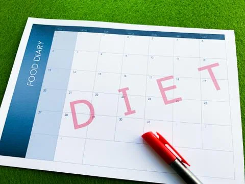 Document diet plan calendar on green background. Stock Photos