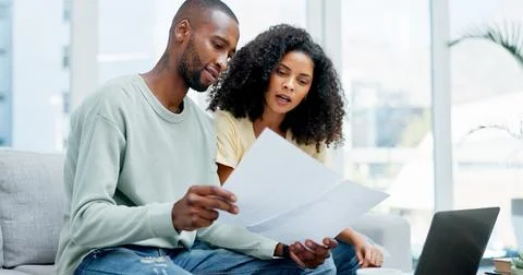 Document, laptop and couple on sofa for planning budget, savings or loan ap.. Stock Photos