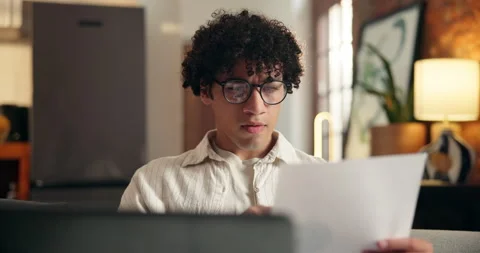 Document, laptop or man with reading for work from home, info comparison or Stock Footage 329373939