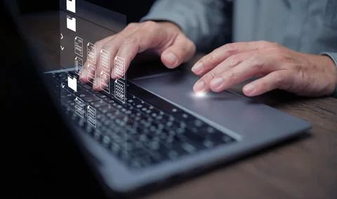 Document Management System concept. A man using DMS software on his laptop .. Stock Photos