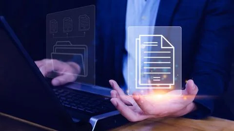 Document Management System (DMS) being setup IT consultant working on lapto.. Stock Photos