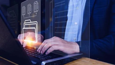 Document Management System (DMS) being setup IT consultant working on lapto.. Stock Photos