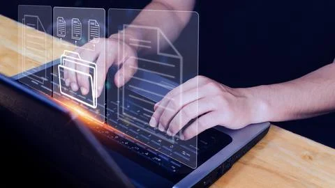 Document Management System (DMS) being setup IT consultant working on lapto.. Stock Photos