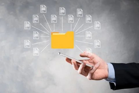 Document Management System DMS .Businessman hold folder and document icon.Sof Stock Photos