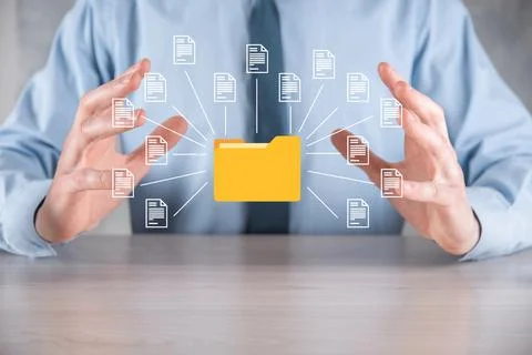 Document Management System DMS .Businessman hold folder and document icon.Sof Stock Photos