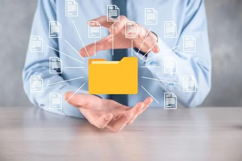 Document Management System DMS .Businessman hold folder and document icon.Sof Stock Photos