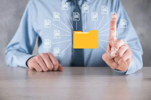 Document Management System DMS .Businessman hold folder and document icon.Sof Stock Photos