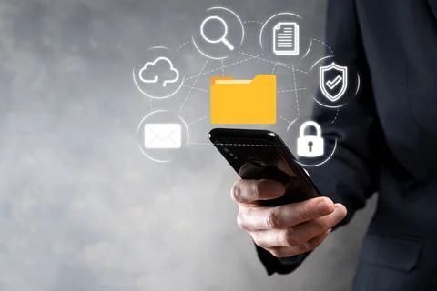 Document Management System DMS .Businessman hold folder and document icon.Sof 写真素材
