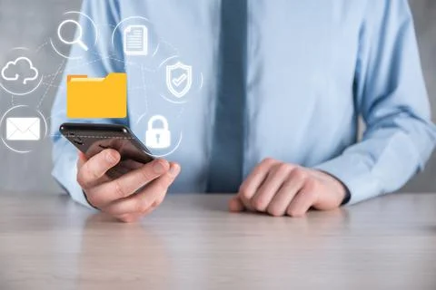 Document Management System DMS .Businessman hold folder and document icon.Sof 写真素材
