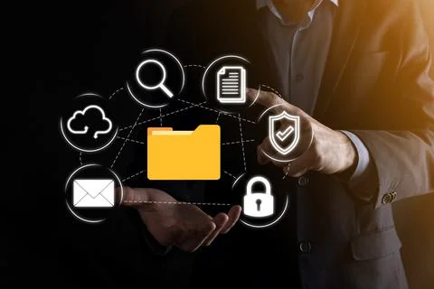 Document Management System DMS .Businessman hold folder and document icon.Sof Stock Photos