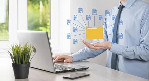 Document Management System DMS .Businessman hold folder and document icon.Sof Stock Photos