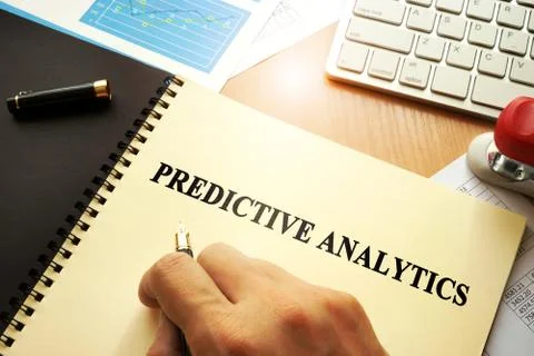 Document with name predictive analytics in an office. Stock Photos