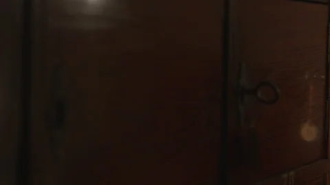 Document pick up from an old wooden key locked file cabinet tracking shot Stock Footage 117983452